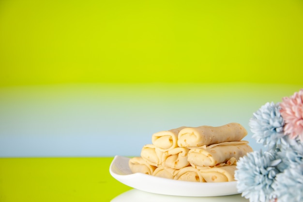 Front view yummy pancakes on green background cake sugar dessert meal cookie breakfast morning color sweet