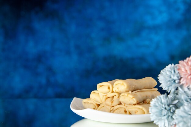 front view yummy rolled pancakes on dark blue background breakfast cake sugar dessert meal morning sweet color cookie