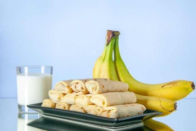 front view yummy rolled pancakes with bananas and milk on light background fruit dessert morning sweet cake color sugar milk