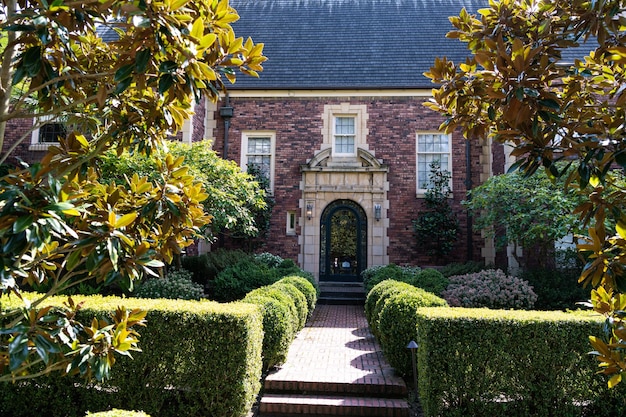 Front yard hedge and path leading to mansion house entrance door