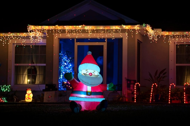 Front yard with brightly illuminated christmas decorations Outside decor of florida family home for winter holidays