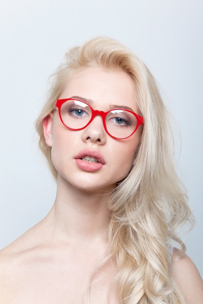 Frontal portrait of blonde woman wearing eyeglasses