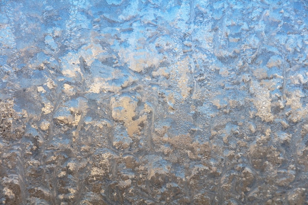 Frost drawing on window glass, snowflake ornament after anomaly ice cold.