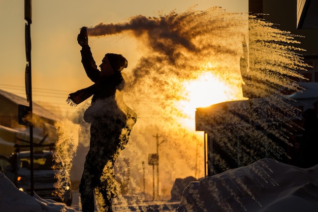 Frost effect hot water freezes man pours boiling water