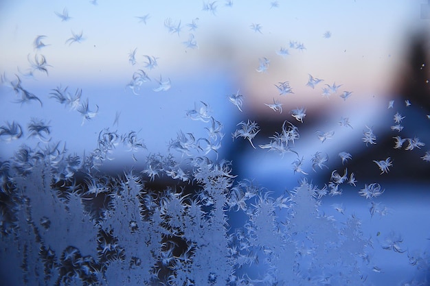 Frost patterns on window glass, abstract background winter rime snow