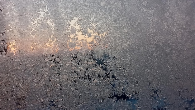 Frost and sun background Frost texture on the window glass in winter Ice Crystals in Winter Blue and Pink