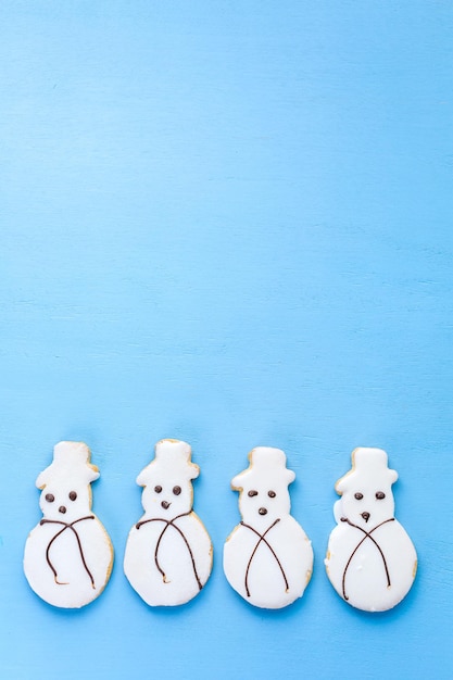 Photo frosted white sugar cookies in shape of snowman.