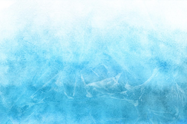 Frosted winter blue watercolor background painted on white paper