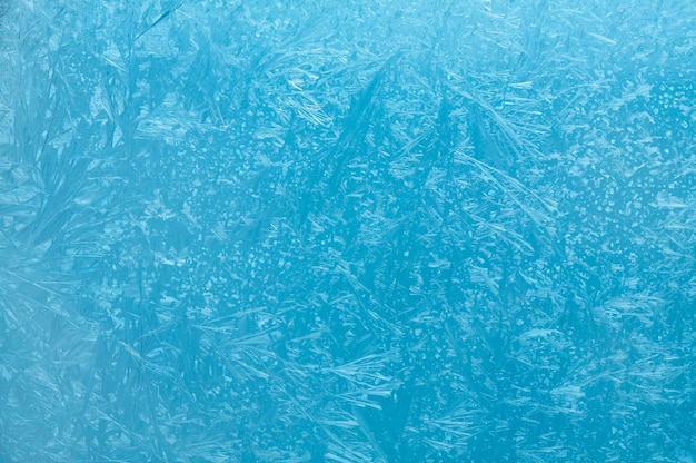 Frosty pattern on glass on a blue background