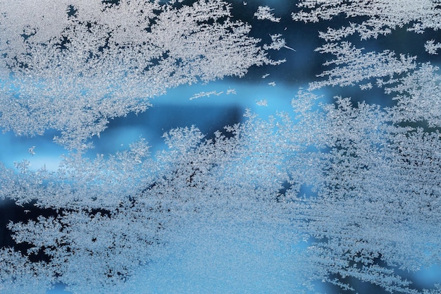 Frosty patterns on a frozen window background