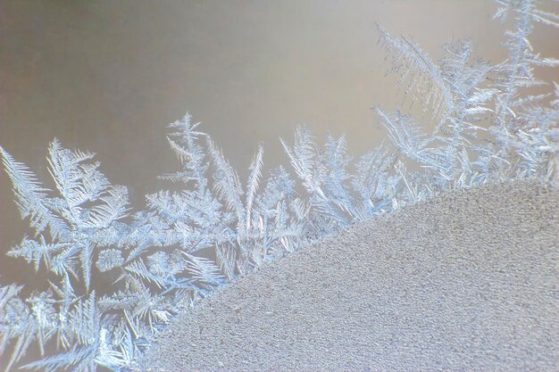 Frosty patterns on the window glass closeup. natural textures and backgrounds. ice patterns on frozen