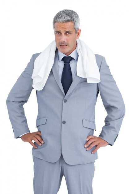 Frowning businessman posing with white towel