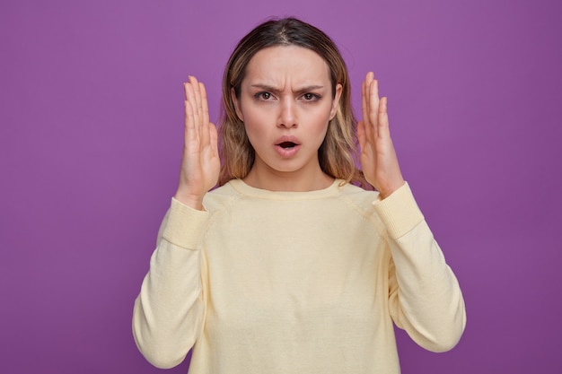 Frowning young girl doing size gesture 