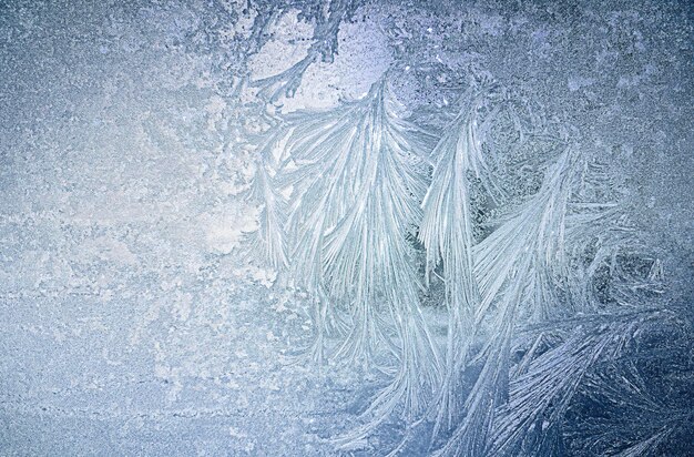 Photo frozen background ice patterns on the window