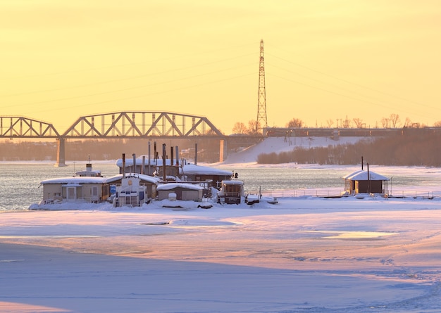 Frozen bank of the Ob River floating pier