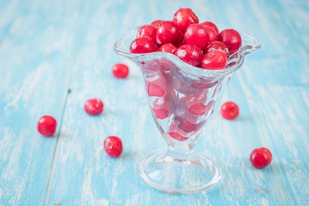 Frozen berries cherry on vintage wooden table.