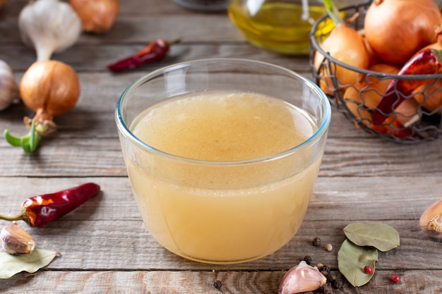 Frozen broth in a container on a wooden table