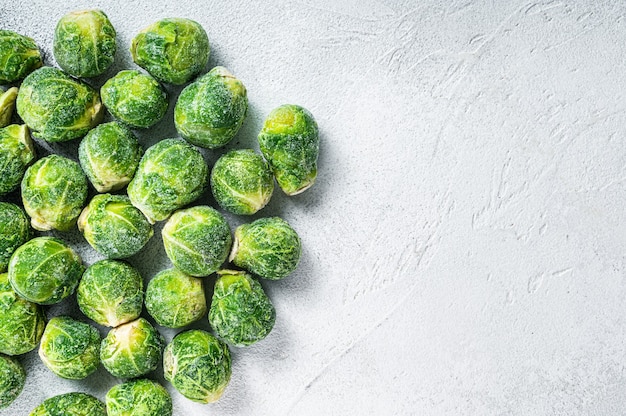 Frozen Brussels sprouts green cabbage on kitchen table