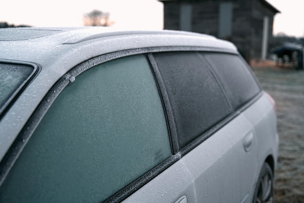 Frozen car on the outside parking Transport in winter Vehicle closeup with frozen windshield and windows