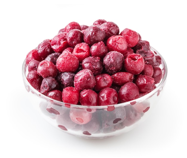 Frozen cherries in glass bowl isolated on white background with clipping path