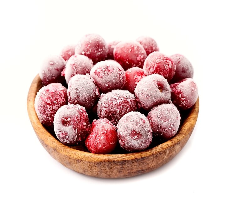 Frozen cherry berries in wooden plate.