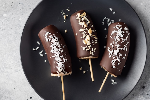 Frozen chocolate covered bananas with toppings Healthy vegan dessert