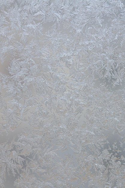 Frozen drops of condensed steam water drops on the transparent\
window glass clean blue background condensation of moisture at\
extreme temperatures beautiful nature texture