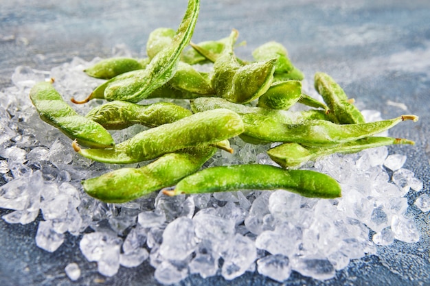 Frozen Edamame or soybeans in the mix with crushed ice