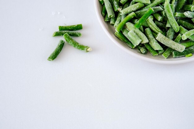 Frozen fresh beans on a light background green string beans\
green beans with ice crystals string beans from the freezer