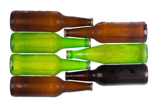 frozen glass beer bottles isolated on white background