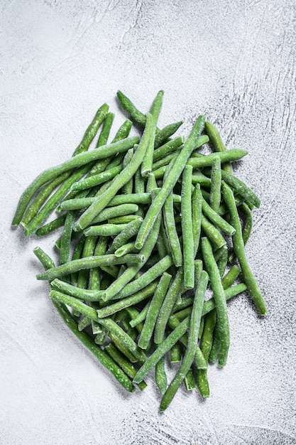 Frozen green beans on the white kitchen table