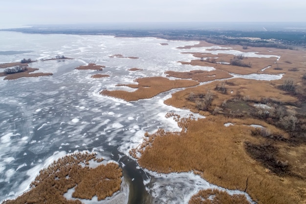 Frozen ice on the shore of the sea as a background, a bird's-eye view. Early winter