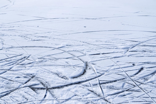 Frozen lake during winter with lots of ice skating tracks