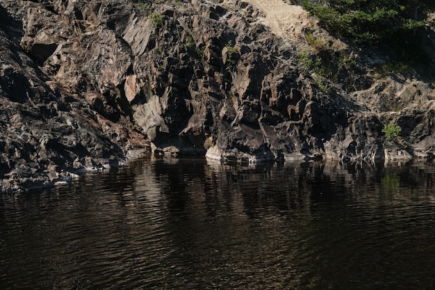 Frozen lava is reflected in the water irvas paleovolcano is popular place among tourists