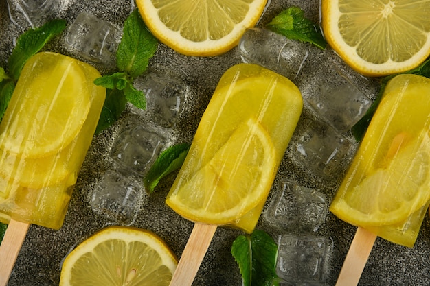 Frozen lemon and mint ice popsicles on the table
