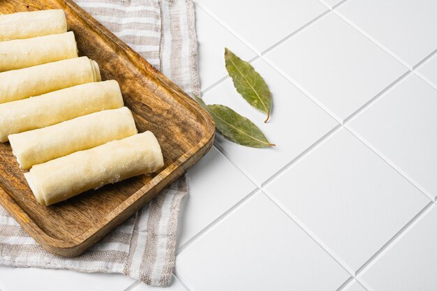 Frozen pancake stuffed on white ceramic squared tile table background with copy space for text