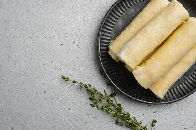 Frozen pancakes with meat on gray stone table background top view flat lay with copy space for text