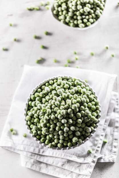 Frozen peas in a white porcelain bowl