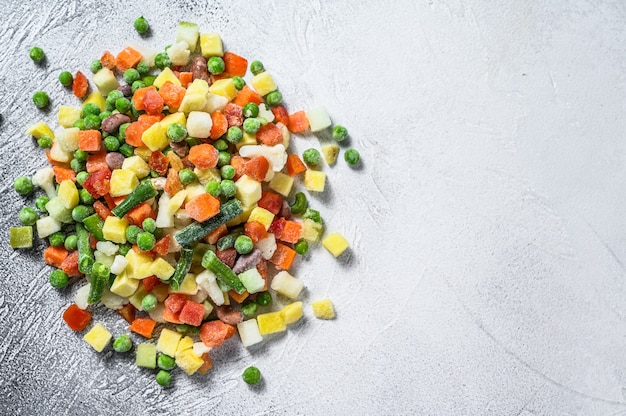 Frozen raw vegetables on white