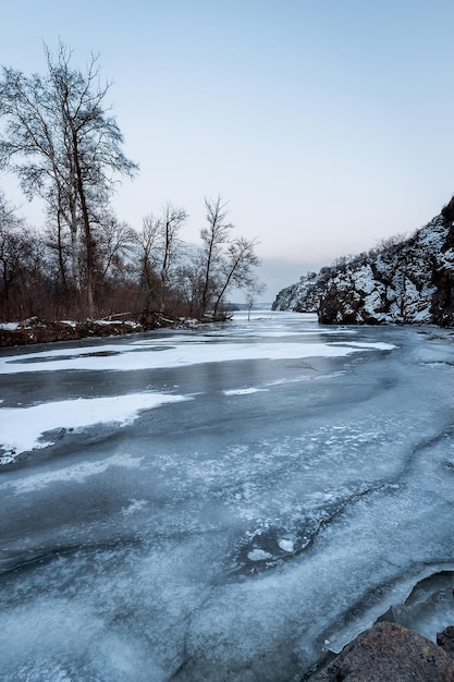 Frozen river in winter among rocks and treesx9