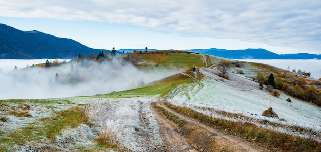 Frozen road against the backdrop of a beautiful sky and fluffy fog