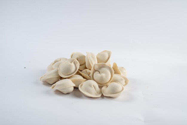 Frozen semifinished dumplings on a white background