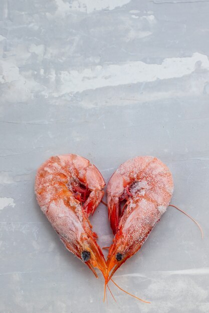 Frozen shrimps on plate on ceramic background