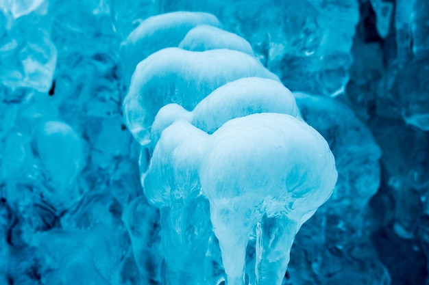 Frozen small mountain blue waterfall close up