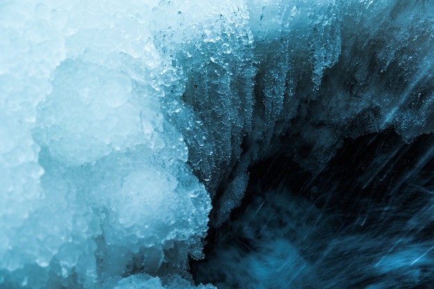 Frozen small mountain blue waterfall close up