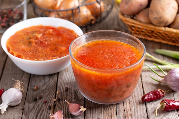 Frozen soup. Borscht in a glass container. Frozen food on a wooden table