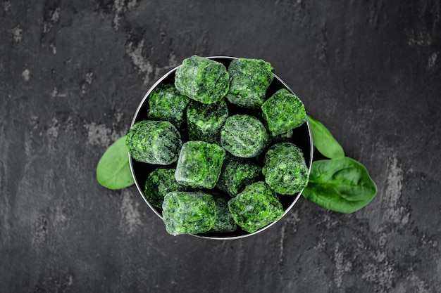 Frozen spinach cubes close up selective focus