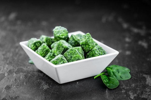Frozen spinach cubes close up selective focus