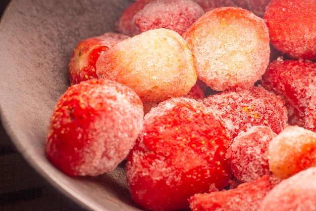 Frozen strawberries in gray bowl