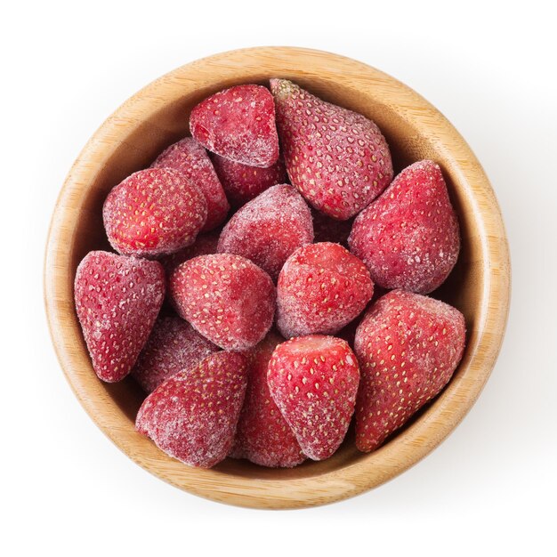 Frozen strawberries in wooden bowl isolated on white background with clipping path